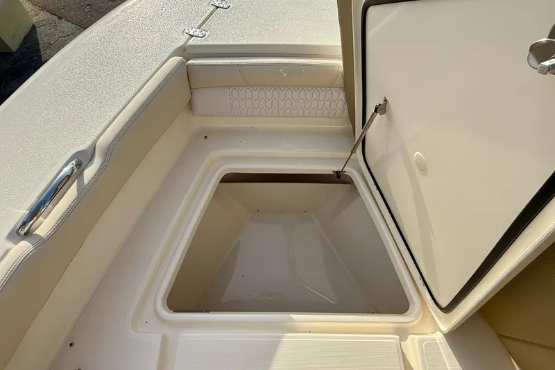 Slide: The Image of 2026 Scout 195 Sport Dorado boat storage compartment with open hatch. - 13
