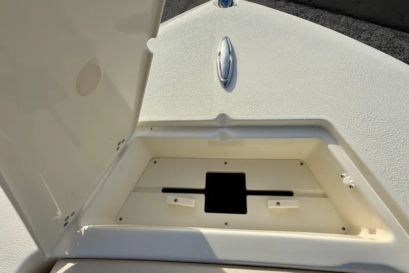 Slide: The Image of Open storage compartment on 2026 Scout 195 Sport Dorado boat deck. - 14