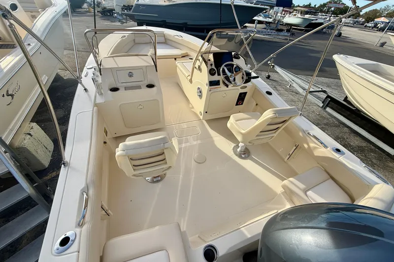 Slide: The Image of 2026 Scout 195 Sport Dorado boat interior with seating and steering console. - 3