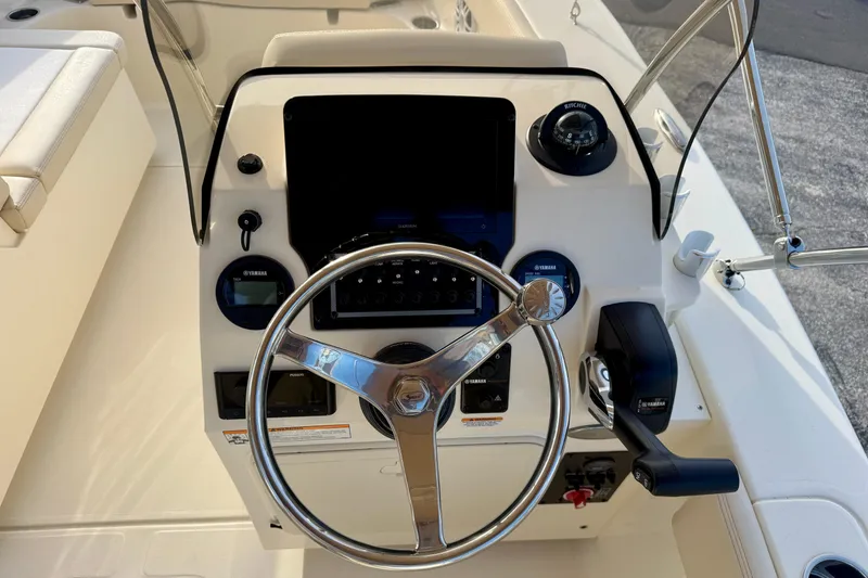 Slide: The Image of 2026 Scout 195 Sport Dorado boat dashboard with steering wheel and controls. - 6