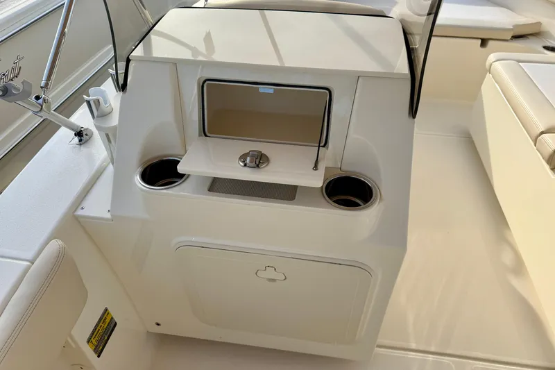 Slide: The Image of 2026 Scout 195 Sport Dorado boat interior with cup holders and storage compartment. - 7
