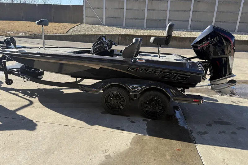 The Image of 2026 Nitro Z19 XL boat on trailer, parked outdoors, featuring sleek black design. - 0