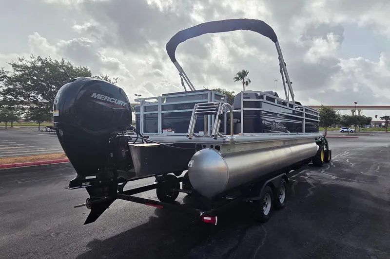 Slide: The Image of 2026 Sun Tracker SportFish 22 DLX pontoon boat with Mercury engine on trailer. - 1