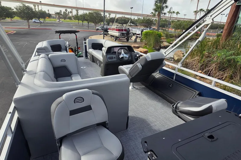 Slide: The Image of 2026 Sun Tracker SportFish 22 DLX pontoon boat interior with plush seating and modern helm. - 5