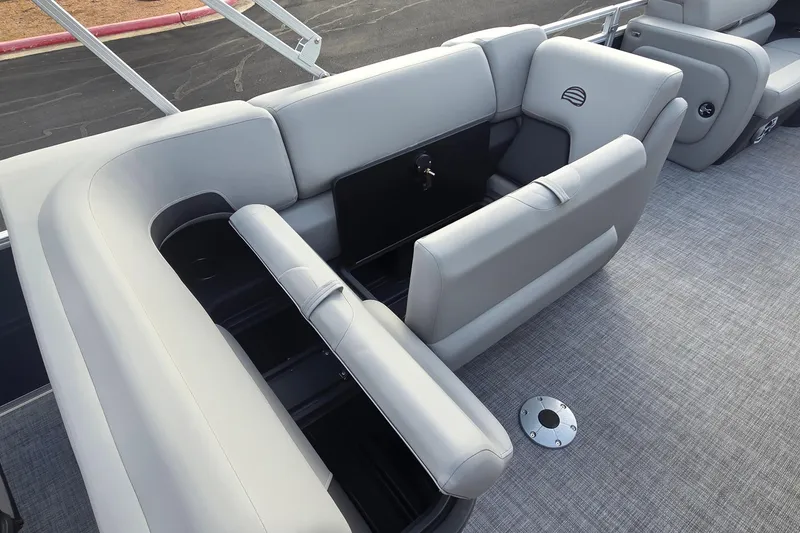 Slide: The Image of 2026 Sun Tracker SportFish 22 DLX boat interior with gray seating and storage compartments. - 10