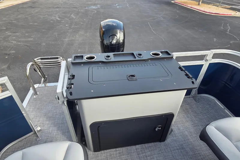 Slide: The Image of 2026 Sun Tracker SportFish 22 DLX boat interior with motor and seating area. - 6