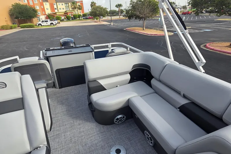 Slide: The Image of 2026 Sun Tracker SportFish 22 DLX pontoon boat interior with gray seating and spacious layout. - 12