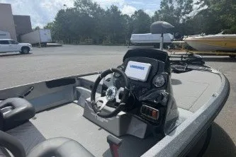 Slide: The Image of 2026 Nitro Z17 boat interior with steering wheel and control panel in a parking lot. - 5