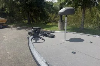 Slide: The Image of 2026 Nitro Z17 boat with trolling motor, parked outdoors near trees. - 3