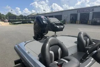 Slide: The Image of 2026 Nitro Z17 boat with motor, parked outside a service center under a cloudy sky. - 6