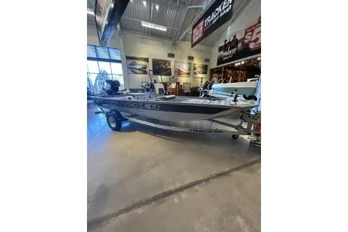 Slide: The Image of 2026 Tracker Bass Tracker Classic CC boat displayed in a showroom. - 2