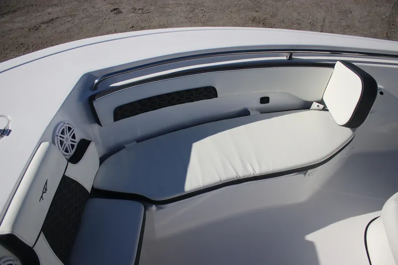 Slide: The Image of 2026 Tidewater 220 LXF boat interior with cushioned seating and speaker system. - 11