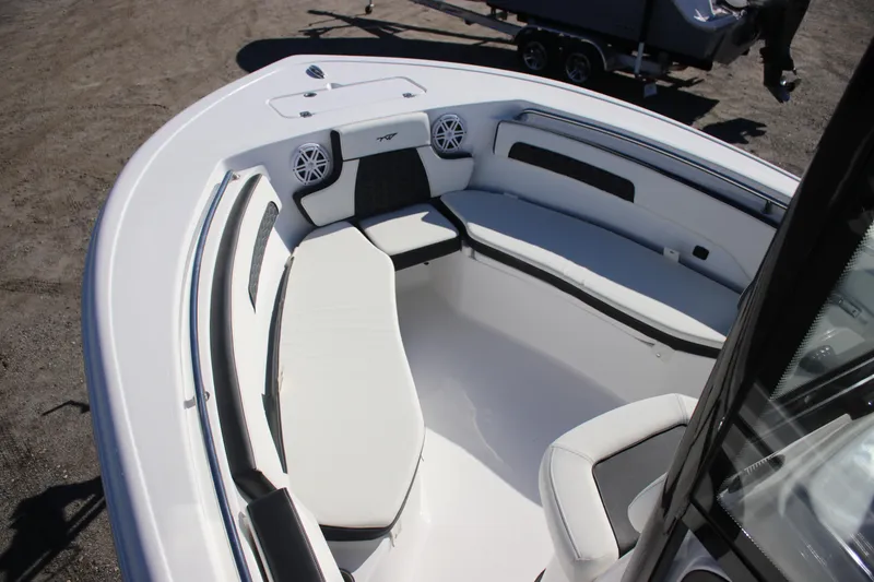 Slide: The Image of 2026 Tidewater 220 LXF boat interior with white seating and speakers. - 13