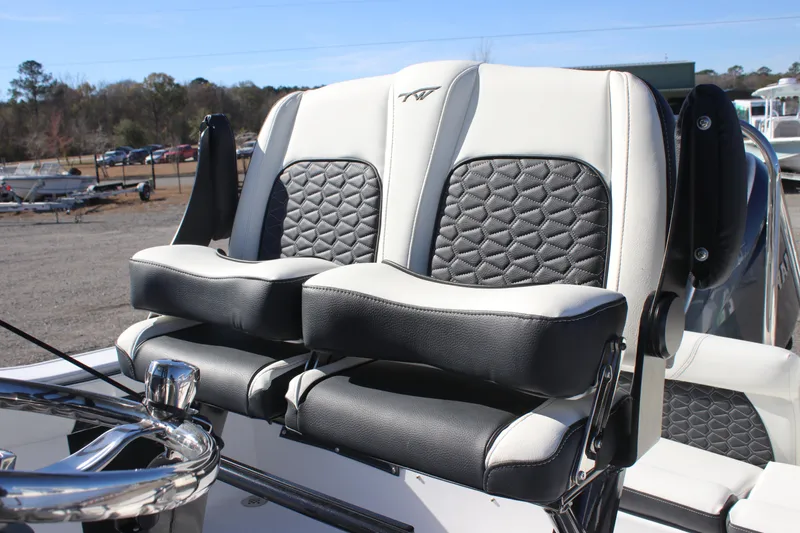 Slide: The Image of 2026 Tidewater 220 LXF boat seats with black and white upholstery, featuring diamond stitching. - 14