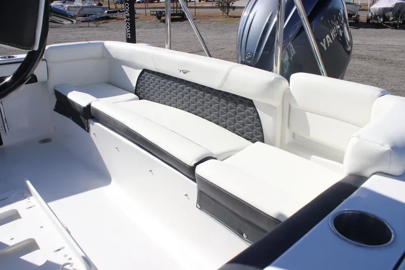 Slide: The Image of 2026 Tidewater 220 LXF boat interior with white seating and Yamaha engine. - 15