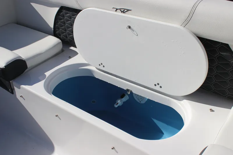 Slide: The Image of 2026 Tidewater 220 LXF boat interior with open storage compartment. - 17