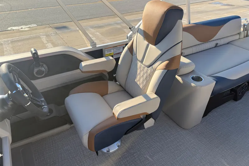 Slide: The Image of 2026 Avalon LSZ Quad Lounger Shift boat interior with captain's chair and console. - 12