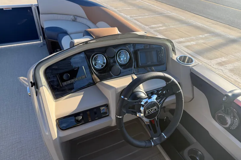 Slide: The Image of 2026 Avalon LSZ Quad Lounger Shift boat dashboard with steering wheel and controls. - 14