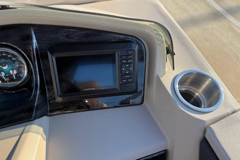 Slide: The Image of 2026 Avalon LSZ Quad Lounger Shift dashboard with Garmin display and cup holder. - 16