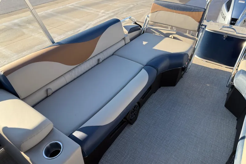 Slide: The Image of 2026 Avalon LSZ Quad Lounger Shift boat interior with stylish seating and cup holder. - 26