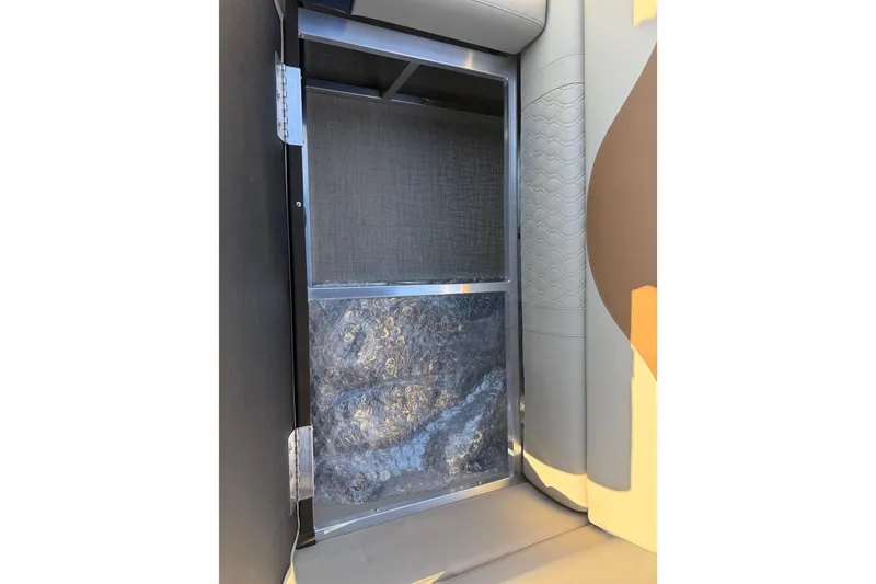 Slide: The Image of 2026 Avalon LSZ Quad Lounger Shift interior storage compartment with bubble wrap. - 33
