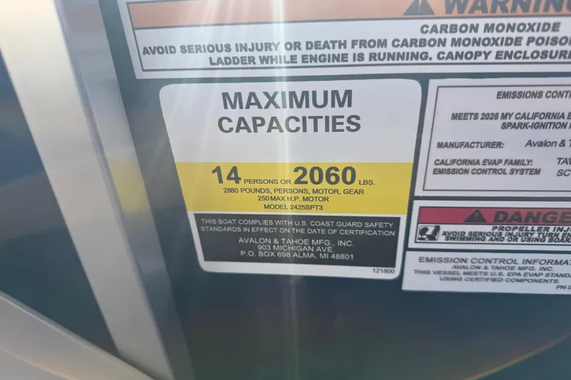 Slide: The Image of 2026 Avalon LSZ Quad Lounger Shift capacity label, 14 persons or 2060 lbs, safety warnings. - 35