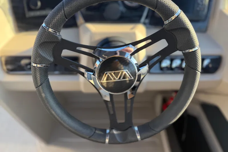 Slide: The Image of Steering wheel of 2026 Avalon LSZ Quad Lounger Shift boat, featuring sleek design and modern controls. - 36
