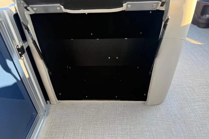 Slide: The Image of Open storage compartment in 2026 Avalon LSZ Quad Lounger Shift boat. - 39