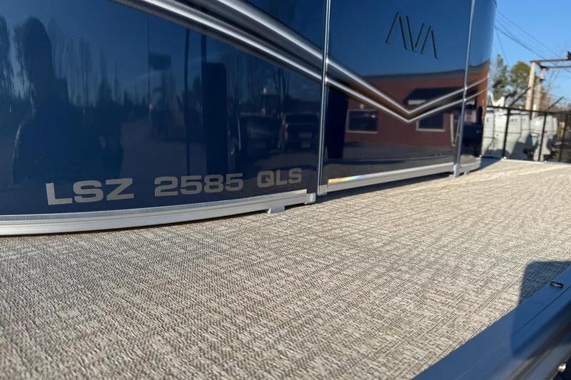Slide: The Image of 2026 Avalon LSZ QUAD LOUNGER SHIFT boat, close-up of model name and sleek design. - 5