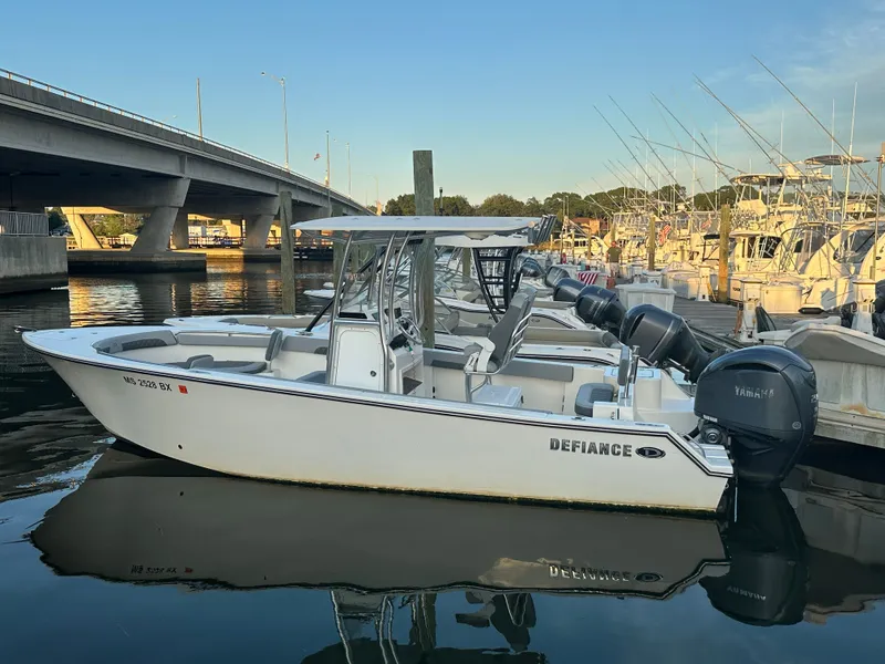 The Image of 2024 Defiance 240 Catalina boat docked in harbor, calm waters. - 0