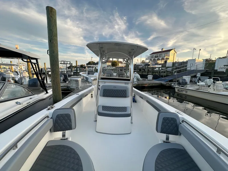 Slide: The Image of 2024 Defiance 240 Catalina boat docked at marina during sunset. - 12