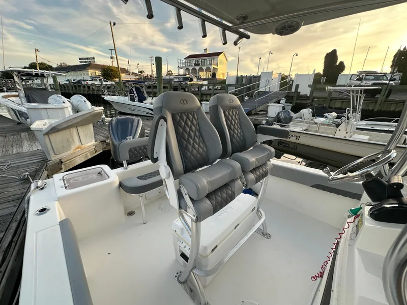 Slide: The Image of 2024 Defiance 240 Catalina boat with luxurious seating at the dock. - 14