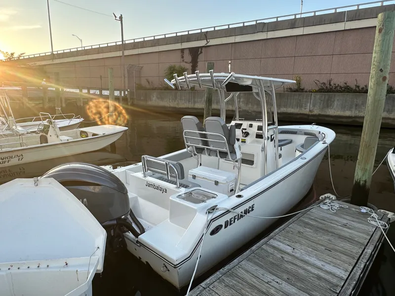 Slide: The Image of 2024 Defiance 240 Catalina boat docked at sunset. - 2