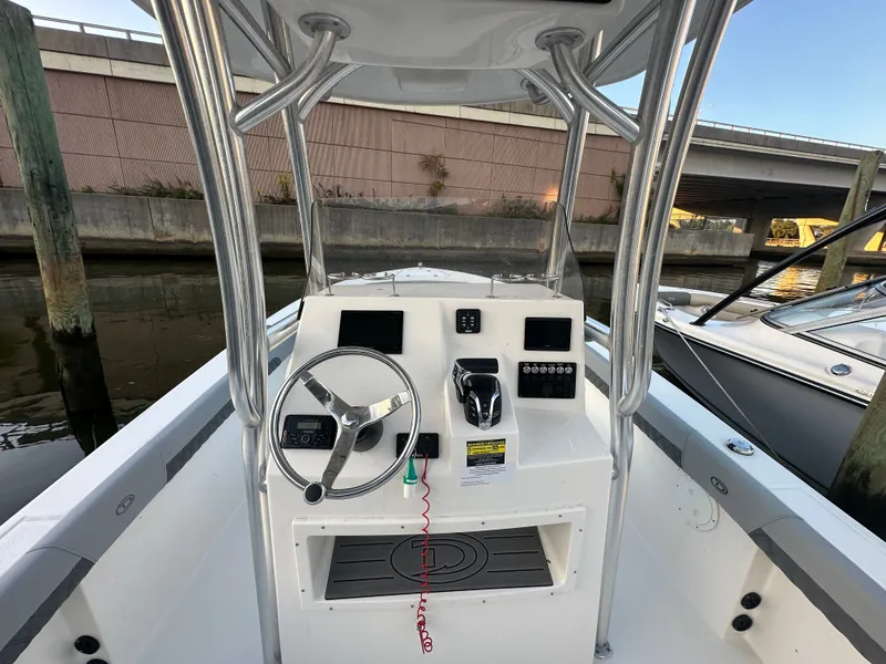 Slide: The Image of Defiance 240 Catalina 2024 helm station at dock. - 5