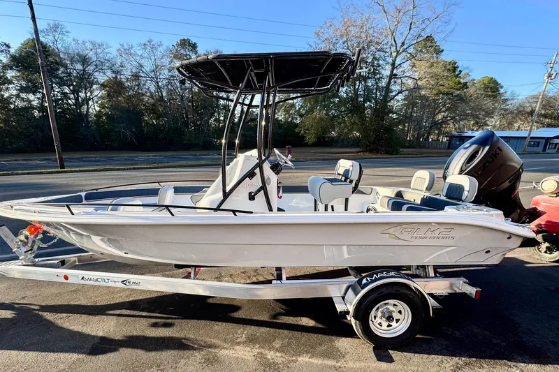 The Image of 2026 ALK2 23 CRX boat on trailer, parked outdoors, with trees in background. - 1