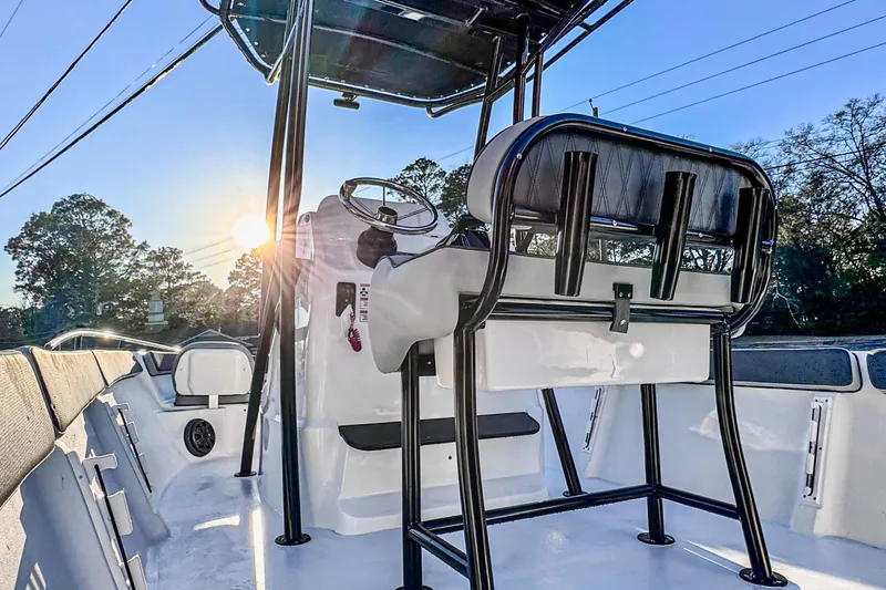 Slide: The Image of 2026 ALK2 23 CRX boat interior with steering console, sunlit background. - 10