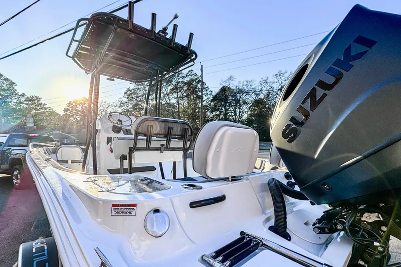 Slide: The Image of 2026 ALK2 23 CRX boat with Suzuki engine, parked outdoors at sunset. - 4