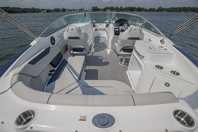 Slide: The Image of Manufacturer Provided Image: 2021 Hurricane SunDeck 2400 OB boat interior with seating and helm on a lake. - 9