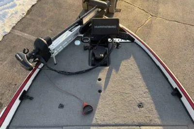 Slide: The Image of 2015 Triton 22 TrX boat deck with fishing equipment and trolling motor. - 10