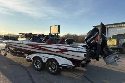 Slide: The Image of 2015 Triton 22 TrX boat with Mercury engine on a trailer in a parking lot. - 5