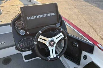 Slide: The Image of 2015 Triton 22 TrX boat dashboard with Humminbird display and steering wheel. - 9