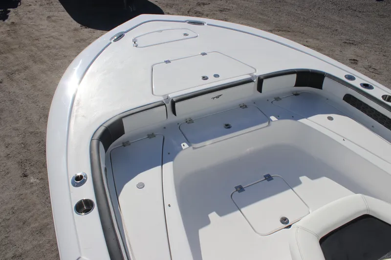 Slide: The Image of 2026 Tidewater 2300 Carolina Bay boat deck with storage compartments and seating. - 10