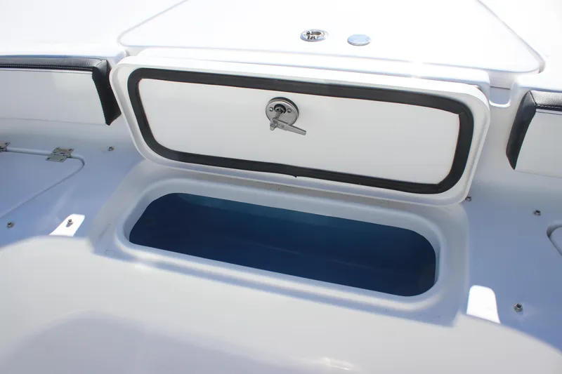 Slide: The Image of 2026 Tidewater 2300 Carolina Bay boat storage compartment with open hatch. - 14