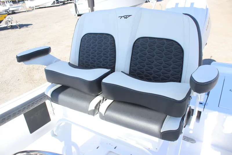 Slide: The Image of 2026 Tidewater 2300 Carolina Bay boat seats with black and white upholstery and armrests. - 15