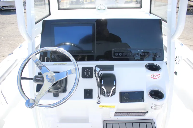 Slide: The Image of 2026 Tidewater 2300 Carolina Bay boat console with steering wheel and electronic controls. - 16