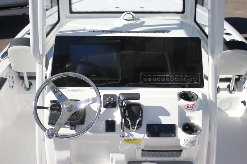 Slide: The Image of 2026 Tidewater 2300 Carolina Bay boat console with steering wheel and navigation controls. - 20