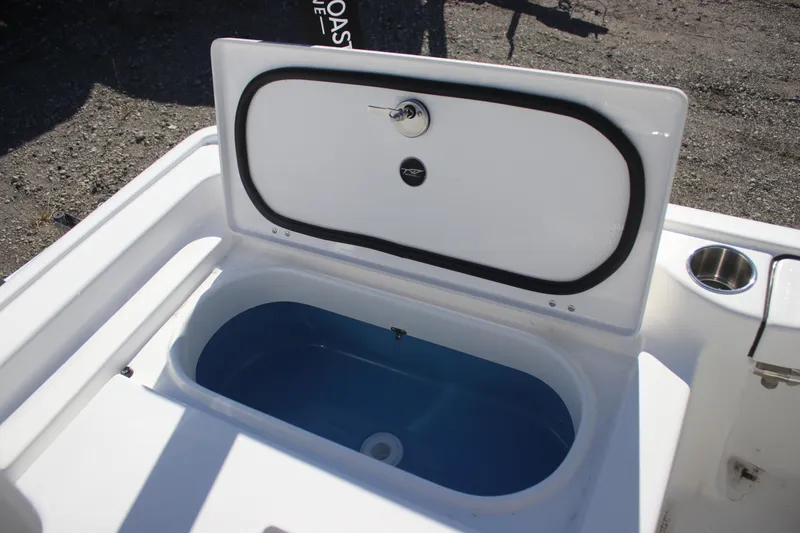 Slide: The Image of 2026 Tidewater 2300 Carolina Bay boat livewell with open lid, showcasing interior. - 23