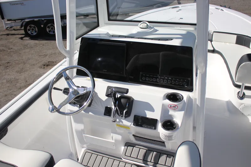 Slide: The Image of 2026 Tidewater 2300 Carolina Bay boat console with steering wheel and controls. - 28