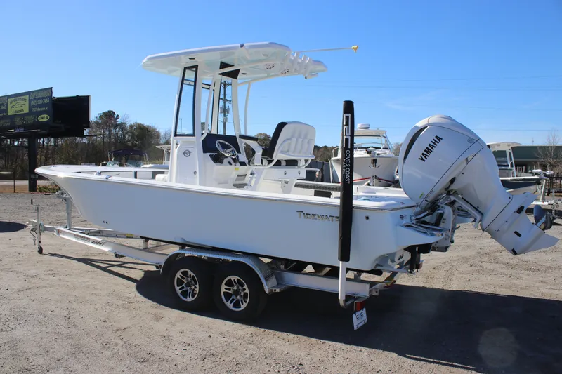 Slide: The Image of 2026 Tidewater 2300 Carolina Bay boat on trailer with Yamaha engine, parked outdoors. - 6