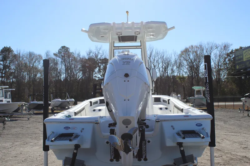 Slide: The Image of 2026 Tidewater 2300 Carolina Bay boat with powerful outboard motor, parked outdoors. - 7
